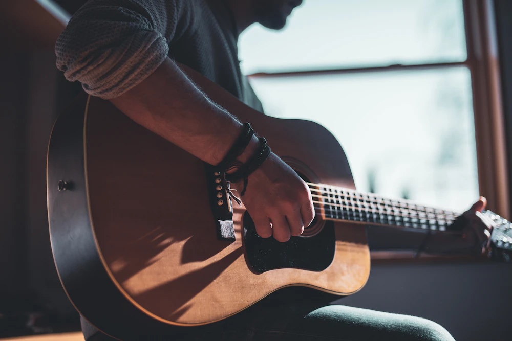 An acoustic guitar showing its wooden body and strings